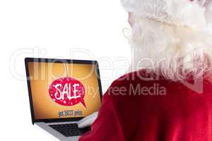 Composite image of santa claus uses a laptop