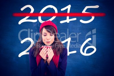 Composite image of festive brunette holding a mug