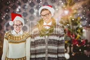 Composite image of smiling man wearing green garland by woman