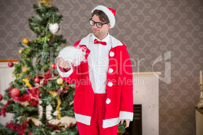 Composite image of geeky hipster in santa costume looking at bea