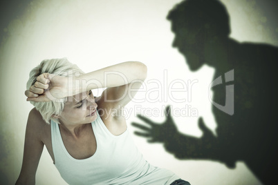 Composite image of depressed woman on the floor