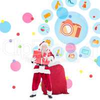 Composite image of santa holding pile of gifts