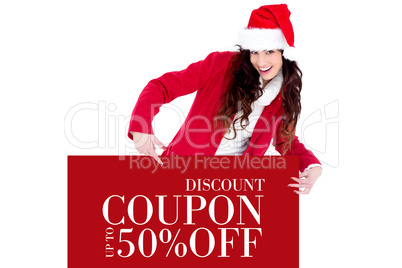 Composite image of festive brunette pointing white poster