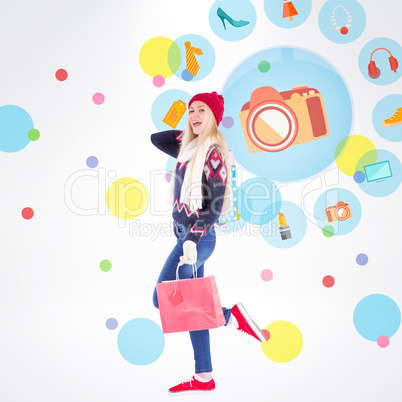 Composite image of festive blonde holding shopping bags