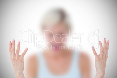 Composite image of angry blonde yelling with hands up