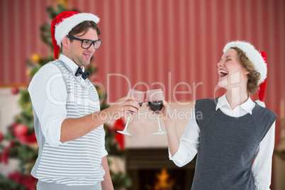 Composite image of happy geeky hipster couple drinking red wine