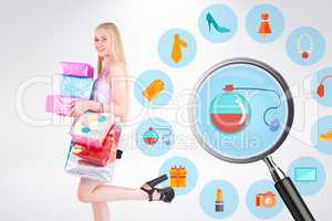 Composite image of pretty young blonde holding shopping bags and