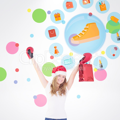 Composite image of festive blonde with boxing gloves and shoppin