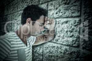 Composite image of upset man leaning on white background