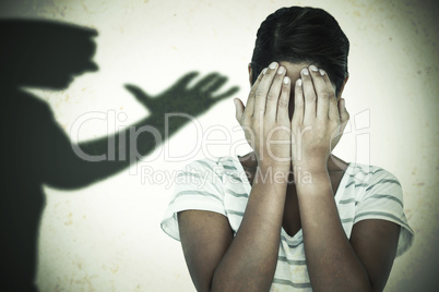 Composite image of close-up of upset woman covering face with ha