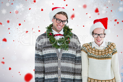 Composite image of smiling man wearing green garland by woman