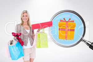 Composite image of happy blonde with shopping bags and gifts