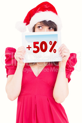 Composite image of festive brunette holding a tablet pc