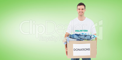 Composite image of attractive man holding donation box with clot