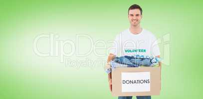Composite image of attractive man holding donation box with clot