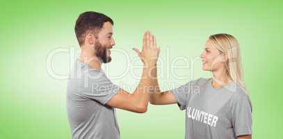 Composite image of smiling volunteer doing high five in office