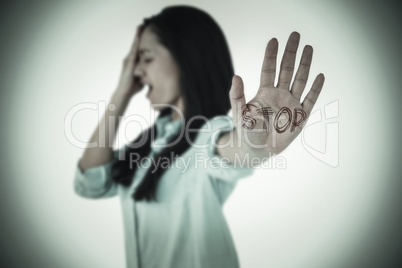 Composite image of irritated woman showing her hand