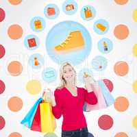 Composite image of happy blonde holding shopping bags