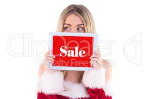 Composite image of pretty santa girl holding tablet