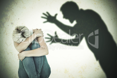 Composite image of depressed woman hiding her head