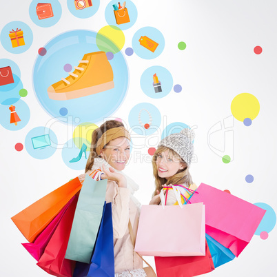 Composite image of beautiful women holding shopping bags looking