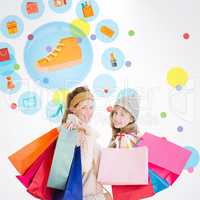 Composite image of beautiful women holding shopping bags looking