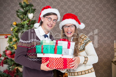 Composite image of portrait of smiling man and woman wearing san