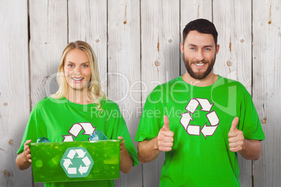 Composite image of portrait of cheerful volunteers in recycling