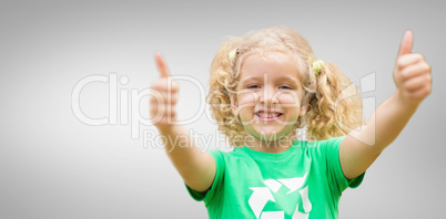 Composite image of happy little girl in green with thumbs up