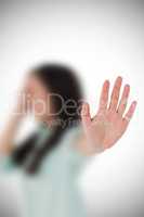 Composite image of irritated woman showing her hand