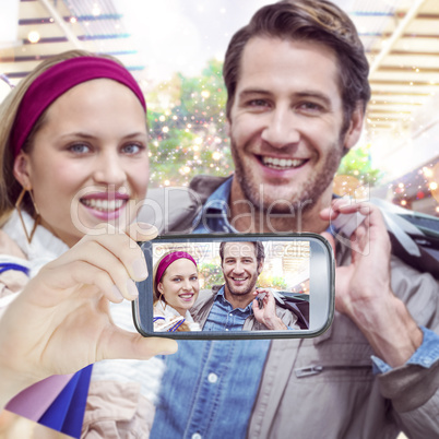 Composite image of hand holding smartphone showing