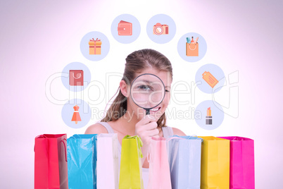 Composite image of woman looking through a magnifying glass