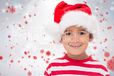 Composite image of cute little boy in santa hat