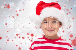 Composite image of cute little boy in santa hat