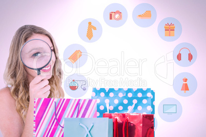 Composite image of smiling woman holding magnifying glass