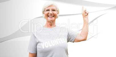 Composite image of happy volunteer grandmother with thumbs up