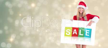 Composite image of pretty santa girl holding poster