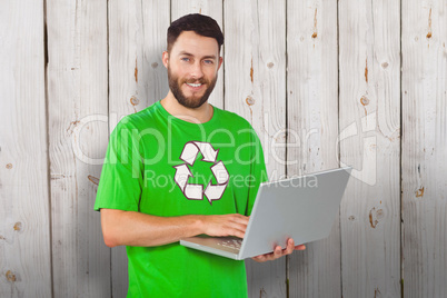 Composite image of portrait of man working on laptop in office