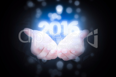 Composite image of businessman holding his hands out