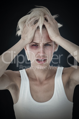 Composite image of sad blonde woman with head pain holding her h