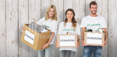 Composite image of portrait of three smiling young people with d