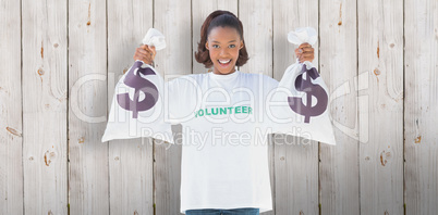 Composite image of smiling volunteer woman holding money bags