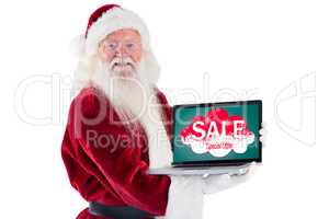 Composite image of santa claus presents a laptop