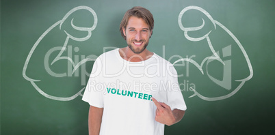 Composite image of smiling man pointing to his volunteer tshirt