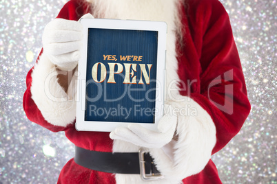 Composite image of santa claus showing tablet pc