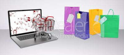 Composite image of trolley full of gifts on laptop