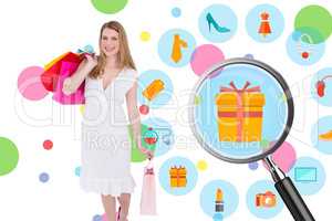 Composite image of happy blonde holding shopping bags in white d