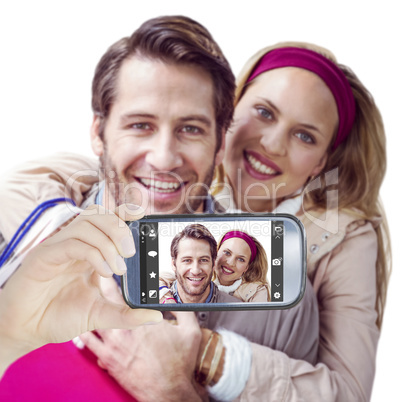 Composite image of hand holding smartphone showing