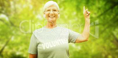 Composite image of happy volunteer grandmother with thumbs up