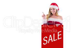 Composite image of festive blonde smiling and pointing